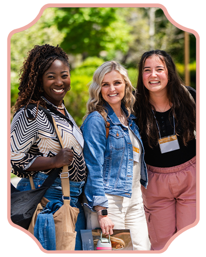 three women pose for camera